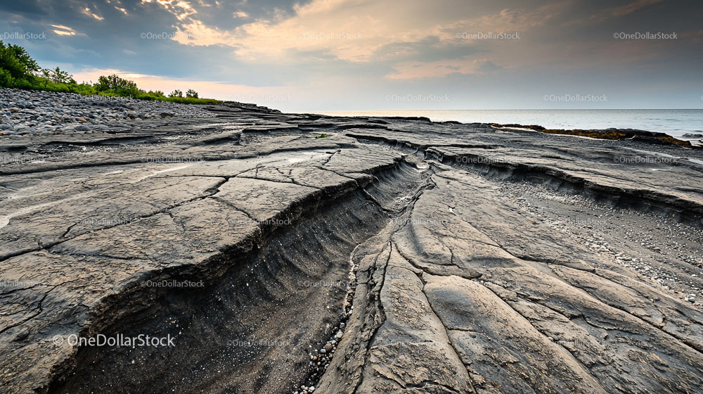 Dramatic Rocky Shoreline with Evening Sky