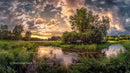 Dramatic Sunset Over Tranquil River and Lush Greenery