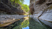 Tranquil River Stream Flowing Through Rocky Canyon