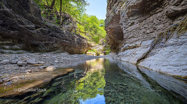 Tranquil River Stream Flowing Through Rocky Canyon