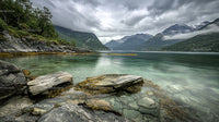 Serene Lake with Rocky Shoreline and Majestic Mountain View