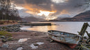 Abandoned Boat by Tranquil Lake with Snowcapped Mountains
