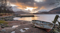 Abandoned Boat by Tranquil Lake with Snowcapped Mountains