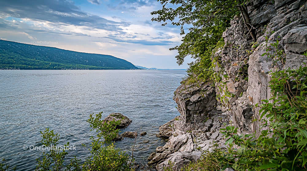 Lakeside Tranquility with Rocky Shore and Verdant Foliage