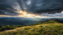 Stunning Sunset Over Green Mountain Ranges and Dramatic Clouds