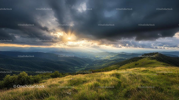 Stunning Sunset Over Green Mountain Ranges and Dramatic Clouds