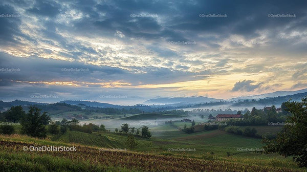 Misty Morning Over Rolling Hills with Dramatic Sky