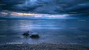 Dramatic Stormy Seascape with Rocky Shore at Dusk