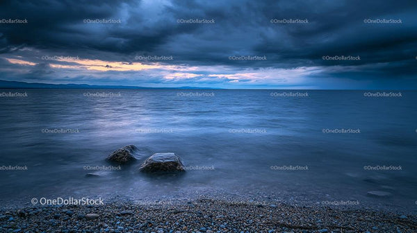 Dramatic Stormy Seascape with Rocky Shore at Dusk