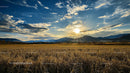 Golden Sunset Over Mountain Landscape and Field