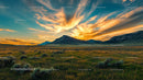Mountain Sunset Over Grassy Meadow with Colorful Sky