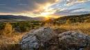 Breathtaking Sunset Over a Mountain Valley with Rocks in Foreground