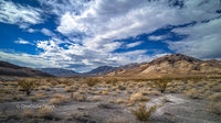 Vast Desert Scene with Rugged Mountains and Expansive Sky