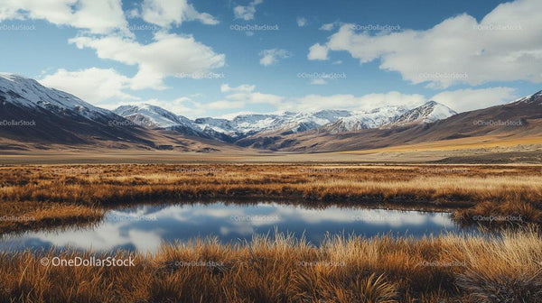 Majestic Snow-Capped Mountains and Serene Lake Reflection