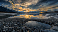 Majestic Sunset Over Mountain Reflections and Rocky Shoreline