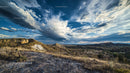 Dramatic Clouds Over Rocky Desert Landscape