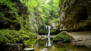 Tranquil Waterfall in a Lush Green Forest Canyon