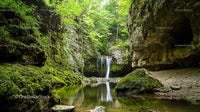 Tranquil Waterfall in a Lush Green Forest Canyon