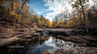 Tranquil Autumn River with Vibrant Foliage and Rocky Banks