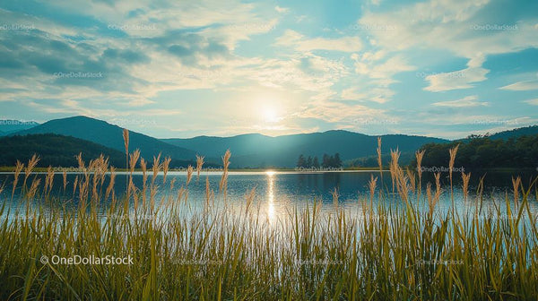 Serene Sunset with Mountains Reflected in a Calm Lake
