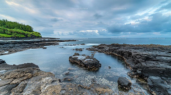 Dramatic Rocky Coastline with Serene Ocean and Clouds