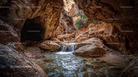 Majestic Canyon with Flowing Waterfall and Rocky Formations