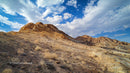 Rocky Gold Mountains Under a Blue Sky