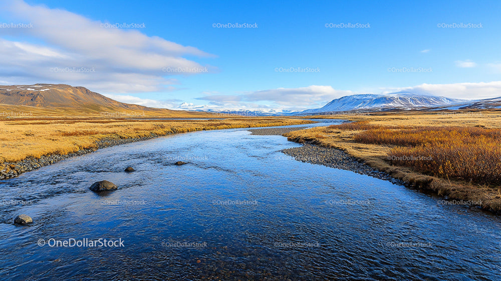 Pristine River Flowing Through Snowy Mountain Landscape
