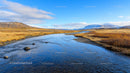 Pristine River Flowing Through Snowy Mountain Landscape