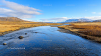 Pristine River Flowing Through Snowy Mountain Landscape