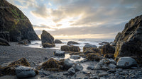 Sunset Over Rugged Rocky Coastline with Serene Ocean View