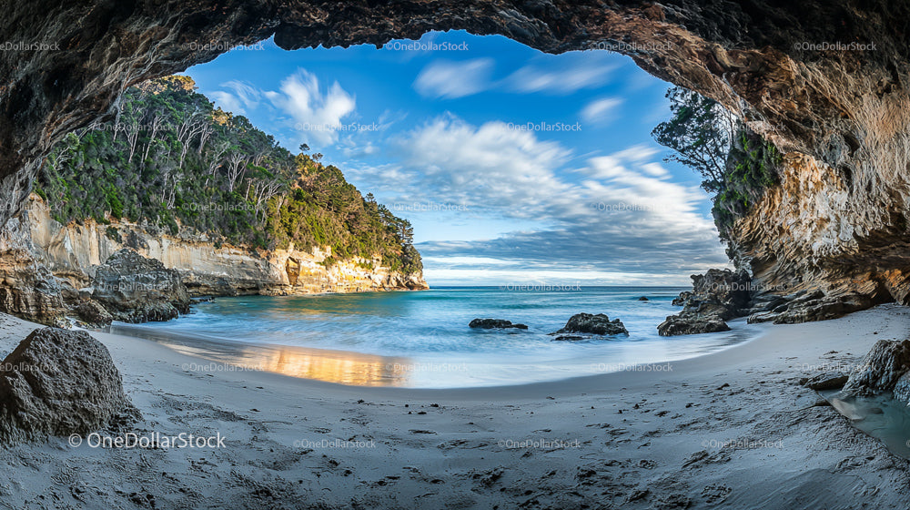 Breathtaking Coastal Cave with Turquoise Sea and Sandy Beach