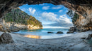 Breathtaking Coastal Cave with Turquoise Sea and Sandy Beach