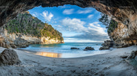 Breathtaking Coastal Cave with Turquoise Sea and Sandy Beach