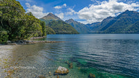 Tranquil Lake Surrounded by Majestic Mountains and Lush Forest