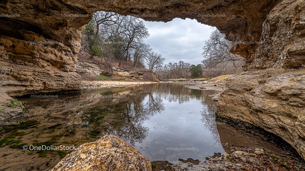 Natural Stone Arch Overlooking Tranquil River and Trees