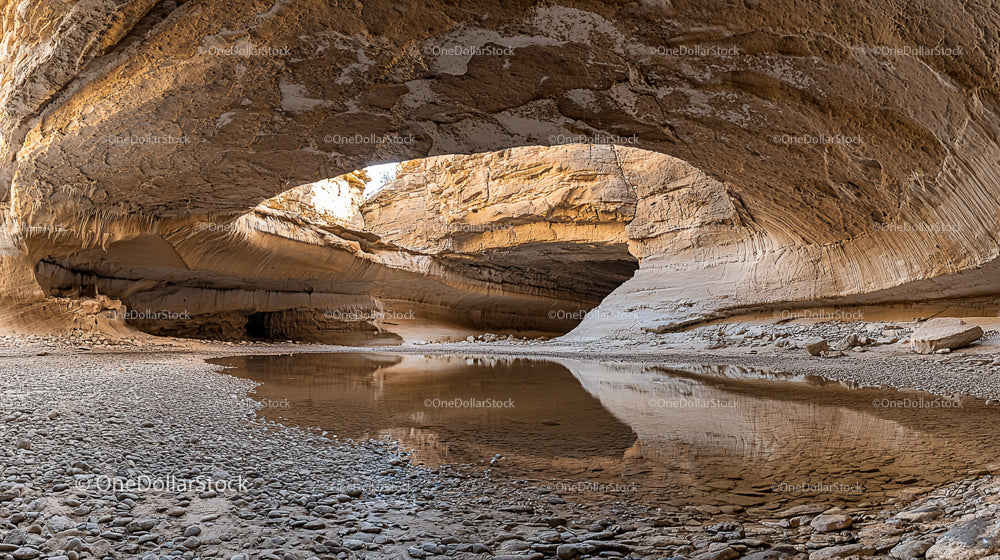 Serene Sandstone Arch with Tranquil Water Reflection