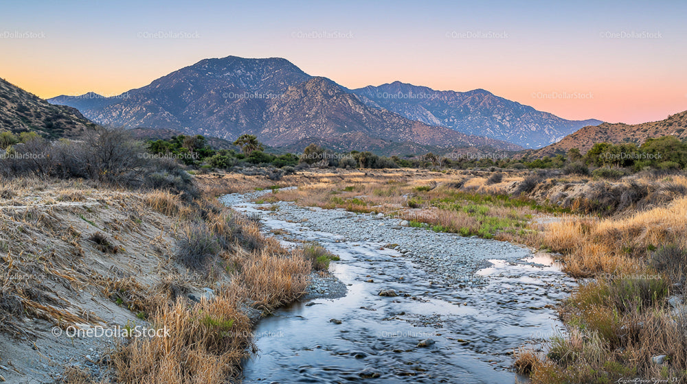 Scenic Mountain Landscape with Serene Stream at Dusk