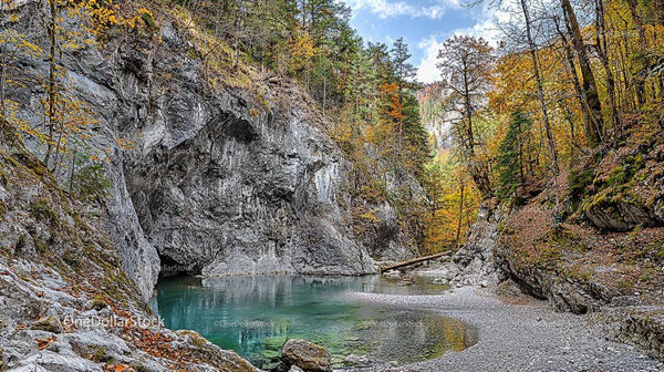Autumn Forest with Turquoise Pond and Rocky Cliffs