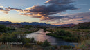 Sunset Over Serene River and Desert Landscape