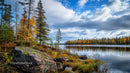 Tranquil Lake with Autumn Trees and Rocky Shoreline