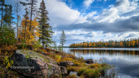 Tranquil Lake with Autumn Trees and Rocky Shoreline