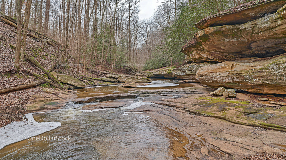Rocky Stream in Winter Forest with Sandstone Formations