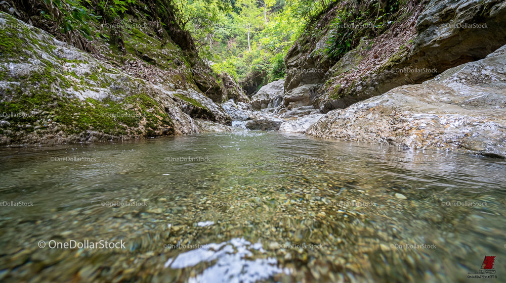 Crystal Clear Stream Flowing Through Rocky Landscape