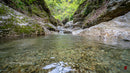 Crystal Clear Stream Flowing Through Rocky Landscape