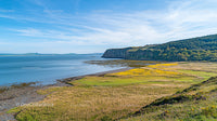 Scenic Coastal View with Blue Ocean and Green Hills
