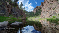 Rocky Canyon with Serene Lake and Pine Forest