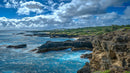 Dramatic Coastal Cliffs Under Vibrant Cloudy Sky