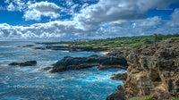 Dramatic Coastal Cliffs Under Vibrant Cloudy Sky