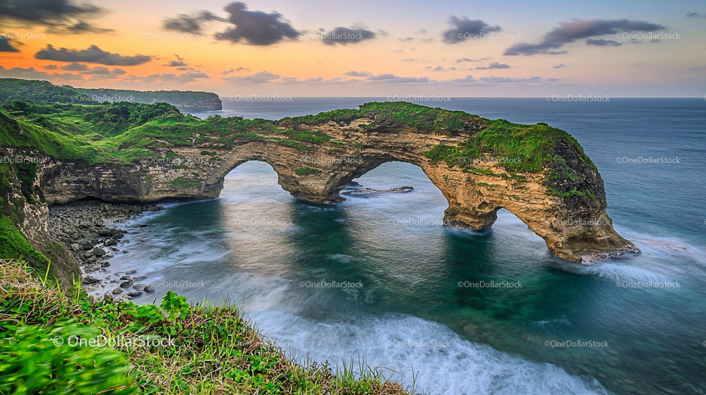 Majestic Natural Arch at Sunset Overlooking Ocean Waves